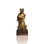 A GILT-LACQUERED WOOD FIGURE OF AN ATTENDANT
China, Qing dynasty (18th century). Height 28 cm.