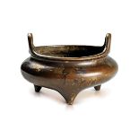 A GOLD-SPLASHED BRONZE TRIPOD CENSER, DING
China, Qing dynasty (18th century). Diameter 14.5 cm.