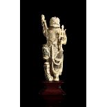 ? AN IVORY FIGURE OF A STANDING GUARDIAN
China, late Qing dynasty. Height 21 cm.
(CITES APPROVAL