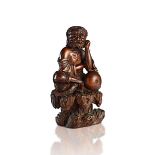 A CARVED WOOD FIGURE OF LI TIEGUAI
China, Qing dynasty (19th century). Height 21 cm.
  Reserve