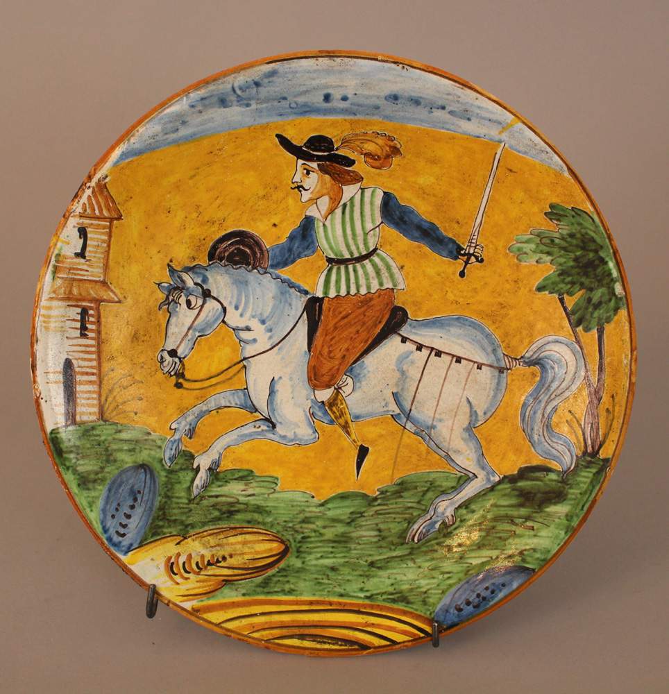 Montelupo ceramic salver, round shape, with painted horse rider in landscape in the centre,