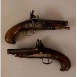 Pair of small duel pistols with carved shaft and partly gilded barrel, flintlock system, the iron