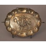 Small silver bowl, oval form with two hand grips and bowed border, in the centre a noble man with