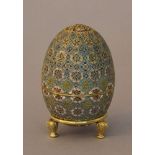 Russian silver egg with rich multicoloured enamel decorations with flowers and the Russian eagle