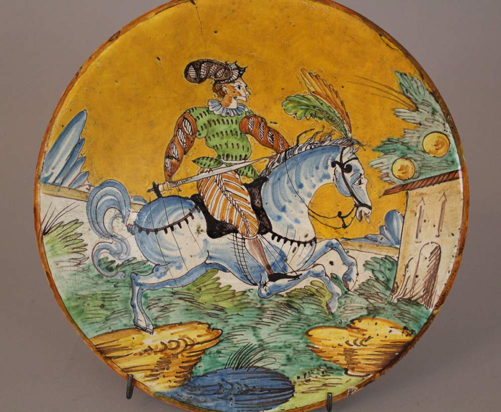 Montelupo ceramic salver, round shape, with painted horse rider in landscape in the centre, - Image 2 of 3