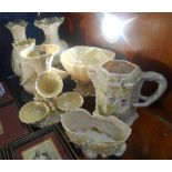 A Belleek Epergne with four trumpet form vases flanked at the base by three shell form dishes, 7 ins