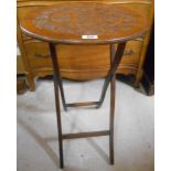 An Edwardian Folding Table with carved top.