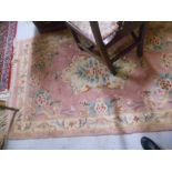 Two Chinese Pink Ground Floral Rugs.