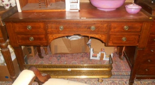 An Edwardian Inlaid Mahogany Kneehole Writing Table with frieze drawer flanked by two further either