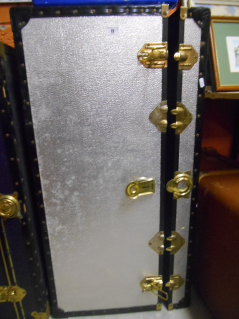 A Brown Portarlington Made Vintage Trunk & a Silver Coloured Steamer Trunk.