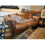 Two Brown Leather Couches (2 Seater + 3 Seater), and a Footstool.