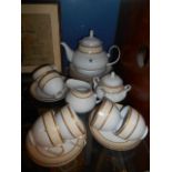 A Porcelain 21 Piece Gold & White Tea Service with Teapot.