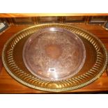 A Large Oval Brass Tray, together with a Silver-Plate Circular Example (2).