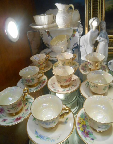 A Set of 12 Demi-Tasse Cups & Saucers, each individually decorated with flowers and with lustrous