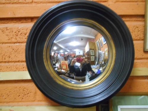 A Regency Style Circular Wall Mirror with stepped ebonised frame & gilt slip.