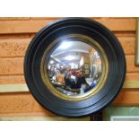 A Regency Style Circular Wall Mirror with stepped ebonised frame & gilt slip.