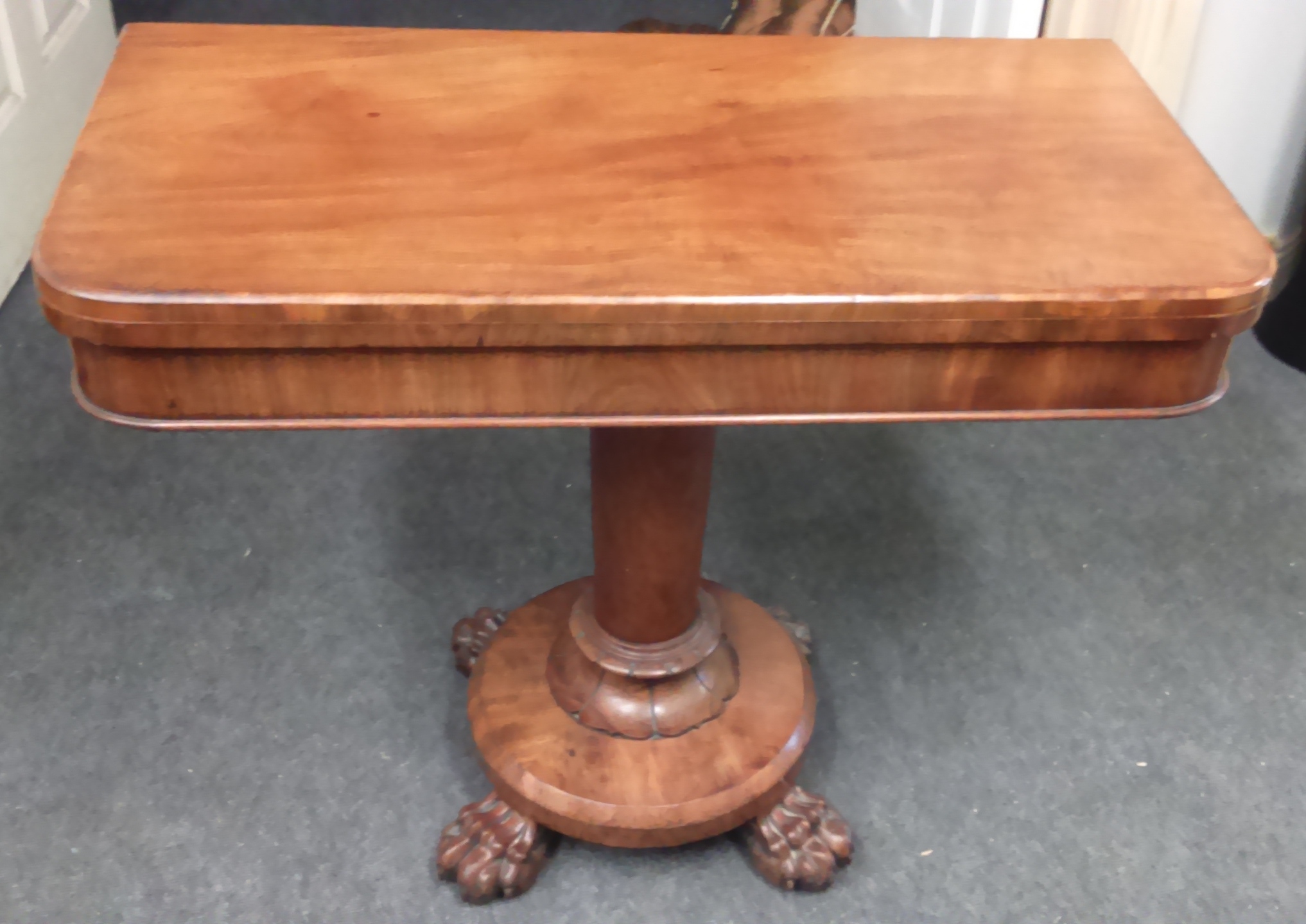 A REGENCY IRISH MAHOGANY CARD TABLE, WITH D-SHAPED FOLD-OVER TOP AND BAIZE LINED INTERIOR, RAISED ON