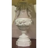 A PAIR OF GERMAN ANTIQUE BLANC DE CHINE PORCELAIN TABLE LAMPS WITH INTERTWINED ROSE AND CHERUB