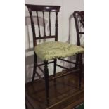 A CHILDS ANTIQUE RAIL BACK OCCASIONAL CHAIR WITH A FULLY UPHOLSTERED GREEN SATIN SEAT ON TURNED