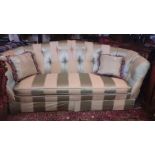A THREE SEATER SATIN UPHOLSTERED DRAWING ROOM COUCH WITH A VARIED GREEN STRIPE DOWN FILLED FITTED