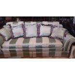 A THREE SEATER SATIN UPHOLSTERED DRAWING ROOM COUCH WITH VARIED GREEN STRIPE DOWN FILLED CUSHIONS,