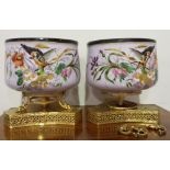 TWO FINE OPAQUE PORCELAIN JARDINIERES ON ORMOLU MOUNTS WITH HAND PAINTED BIRD AND FLORAL PATTERN.