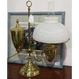AN ANTIQUE OIL LAMP IN BRASS WITH AN OPAQUE WHITE GADROONED SHADE AND CHIMNEY, NOW CONVERTED FOR