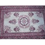 A Small Silk Carpet, with geometric motifs and multi border against a red ground