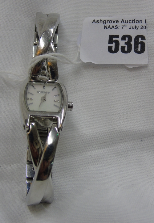 A Ladies DKNY Bracelet watch, with mother of pearl dial.