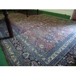 A Carpet with Central Medallion on Red & Blue Ground with alternating borders.