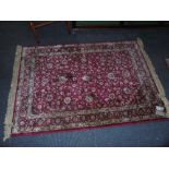 A Persian Red Ground Kashmir Rug - with an all over red floral design. Approx. 6ft x 46ins.