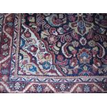 A Red Ground Hand Woven Persian Rug, 206 x 132cm.