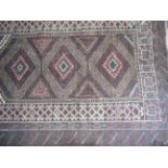 An Afghan Baluchi Tribal Rug on brown ground, 52" x 34".