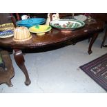 A Early to Mid 20th Century Mahogany Oval Dining Table with single leaf and cabriole legs.