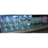 A Collection of Amber Stemmed Wine Glass and Other Glasses.