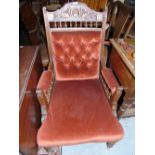 An Early 20th Century Stained Armchair with rust coloured upholstery.