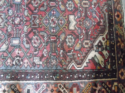 A Red Ground Hand Woven Persian Rug, approx. 6ft 6ins x 4ft 6ins.