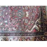 A Red Ground Hand Woven Persian Rug, approx. 6ft 6ins x 4ft 6ins.