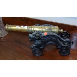 A Late 19th Early 20th Century Brass and Cast Cannon.