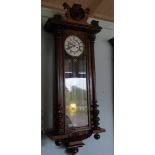 A 19th Century Walnut Vienna Wall Clock with brass and enamel dial.