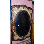 An Italian Oval Bevelled Mirror Mounted on a Parquetry Panel.