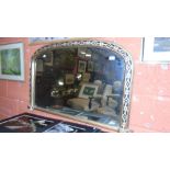 A Victorian Gilt Framed Overmantel Mirror of Arched Form, with running stylised floral detail raised