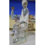 A Lladro Figure of a Girl on a Seat.