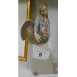 A Lladro Figure of a Girl holding a Turkey.