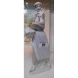 A Lladro Figure of a Girl Holding a Hen and Basket.