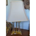 A Brass and Glass Table Lamp, fitted with a cream shade.