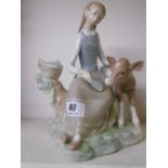 A Lladro Figure of a Girl Feeding a Calf.