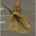 Small miniature porcelain doll with brow