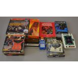 A mixed box of hand-held computer games.