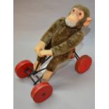 Steiff Original monkey on cart.